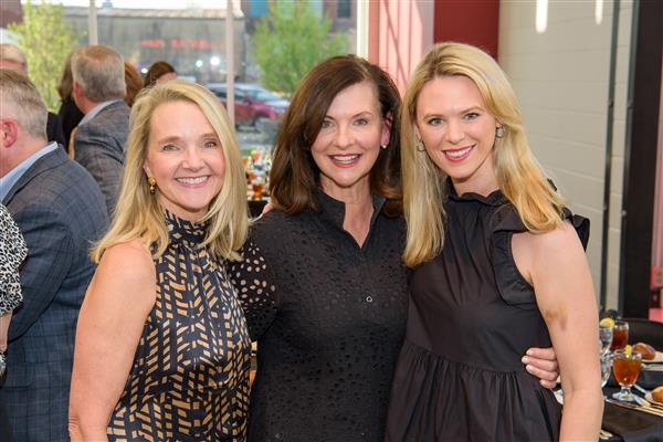 Kelli Hearsill, Charlotte Brown and Caroline Smith smile to camera.